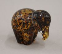 A glass paperweight formed as an elephant. 8 cm high.