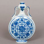 A Chinese blue and white porcelain moon flask Of typical form, with twin scrolling handles,