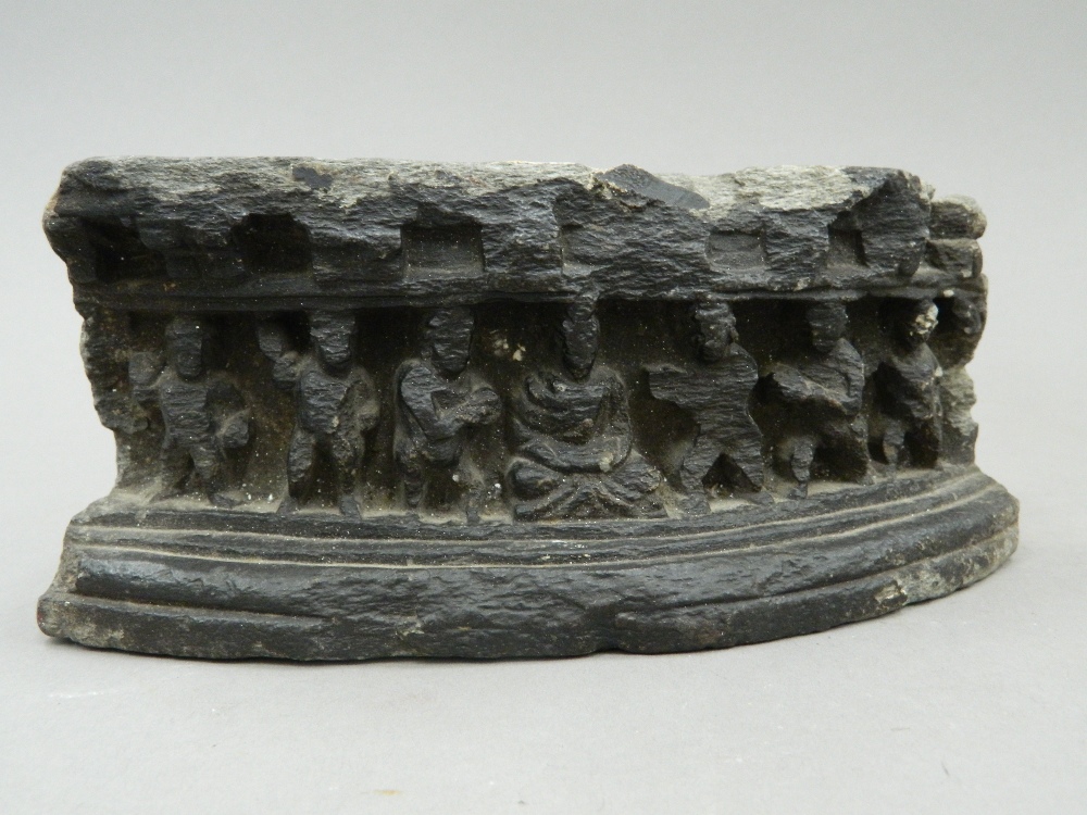 An antique Eastern stone fragment, of curved form, carved with figures wearing offerings to Buddha. - Image 2 of 6