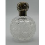 A silver topped cut glass scent bottle. 10 cm high.