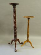 A mahogany torchere and a yewwood veneered torchere. The former 141.5 cm high.