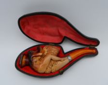 A cased Victorian Meerschaum pipe decorated with Leda and the Swan. 12 cm long.