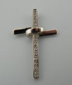 A 9 ct white gold and diamond cross. 3 cm high (2.