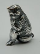 A vesta formed as a gentleman on a potty. 4.5 cm high.