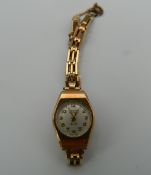 A 9 ct gold cased ladies Tegra wristwatch (13.1 grammes total weight).