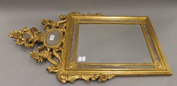 A gilt framed wall glass. 87 cm high.