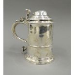 A George II silver lidded tankard, hallmarked for London 1742, maker's mark of F Spilsbury. 17.