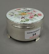 A fine hallmarked silver trinket box with hinged enamelled lid decorated with flowers.