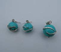 A pair of silver and turquoise earrings with matching pendant. The pendant 2 cm high.