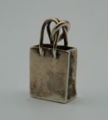 A Tiffany & Co 925 silver charm formed as a bag. 2 cm high (5.8 grammes).