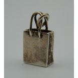 A Tiffany & Co 925 silver charm formed as a bag. 2 cm high (5.8 grammes).