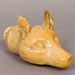 A 19th century stoneware spirit flask Formed as a fox mask. 18.5 cm long.