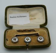A boxed set of buttons and a stock pin