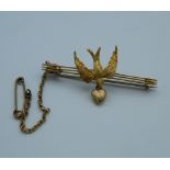 A 9 ct gold bar brooch set with a swallow and a heart (pin not gold). (3.