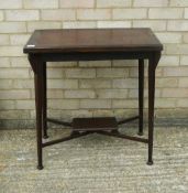 An Edwardian swivel top mahogany games table. 71 cm wide.