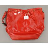 A red Louis Vuitton handbag. 36 cm wide.