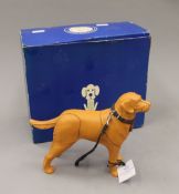 A boxed Battersea Dogs Home Sir Elton John and Mulberry model. The box 24 cm wide.