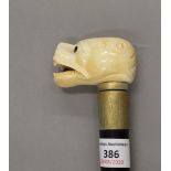 A walking stick with a carved bone handle formed as a dog. 89 cm long.