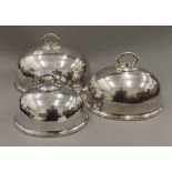 Three silver plated meat covers. The largest 36 cm wide.