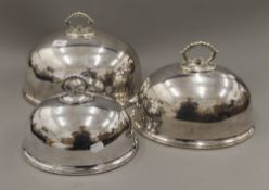 Three silver plated meat covers. The largest 36 cm wide.