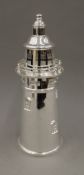 A silver plated cocktail shaker formed as a lighthouse. 36 cm high.