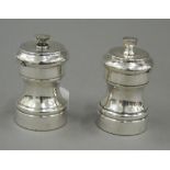 Two sterling silver pepper mills. 7 cm high (5.