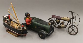 Three models; a car, a motorbike and a boat. The car 30 cm long.