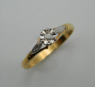 An 18 ct gold illusion set diamond solitaire ring. Ring Size P.