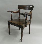 A 19th century oak solid seated open armchair and a Victorian mahogany dining chair. The former 56.