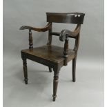 A 19th century oak solid seated open armchair and a Victorian mahogany dining chair. The former 56.