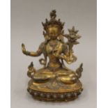 A gilt bronze model of Buddha decorated with coral and turquoise. 21 cm high.