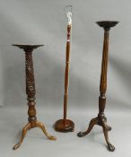 Two mahogany torcheres and a standard lamp. The lamp 171 cm high.