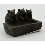 A Japanese bronze model of three piglets at a trough. 4.5 cm wide.