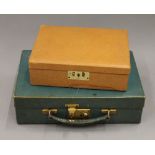 A jewellery box and a small leather case. The former 23 cm wide.