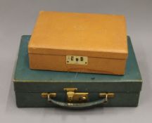 A jewellery box and a small leather case. The former 23 cm wide.