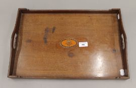 An Edwardian mahogany tray inlaid with a cypher. 47.5 cm wide.