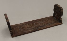 An Eastern carved wooden folding book rack. 29.5 cm long.