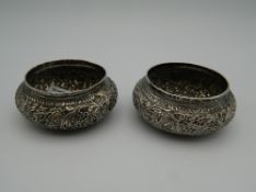 Two Eastern unmarked white metal salts. Each 6 cm wide.