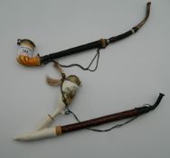 A 19th century horn and Meerschaum pipe, together with another. The former 34 cm long.