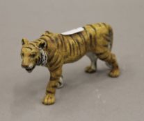 A cold painted bronze model of a tiger. 10.5 cm long.