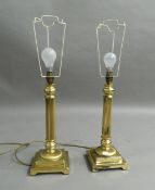 A pair of columnar form brass lamps