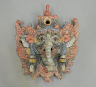 A quantity of miscellaneous Oriental items, including wall masks, a seated noble,