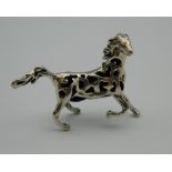 A silver pin cushion in the form of a horse. 4 cm wide.