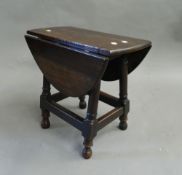 A small oak drop-leaf gate-leg table. 49 cm wide.