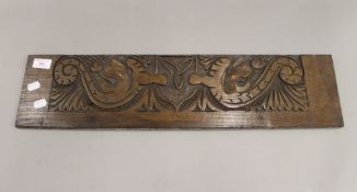 A late 19th/early 20th century oak carved panel. 64 cm wide.