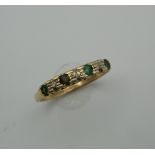 A 9 ct gold emerald and diamond ring. Ring Size N/O (1.