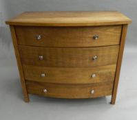 A modern bowfront chest of drawers. 96.