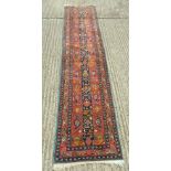 An Afghan wool runner. 325 x 76 cm.