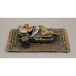 A cold painted bronze model of a sleeping girl.