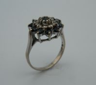 An 18 ct white gold diamond and sapphire ring. Ring size N (4.